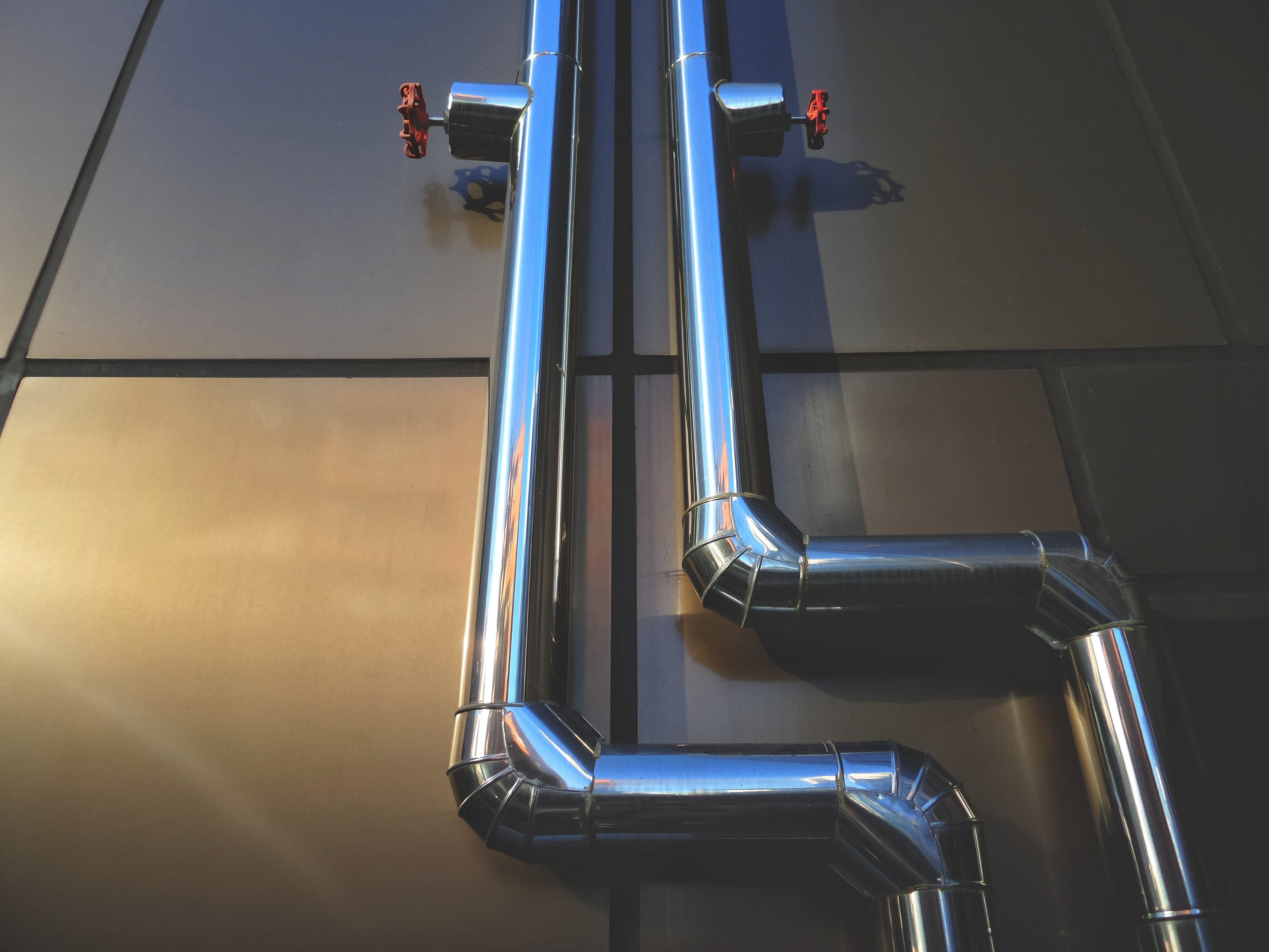 Chrome steel plumbing pipes with red valves